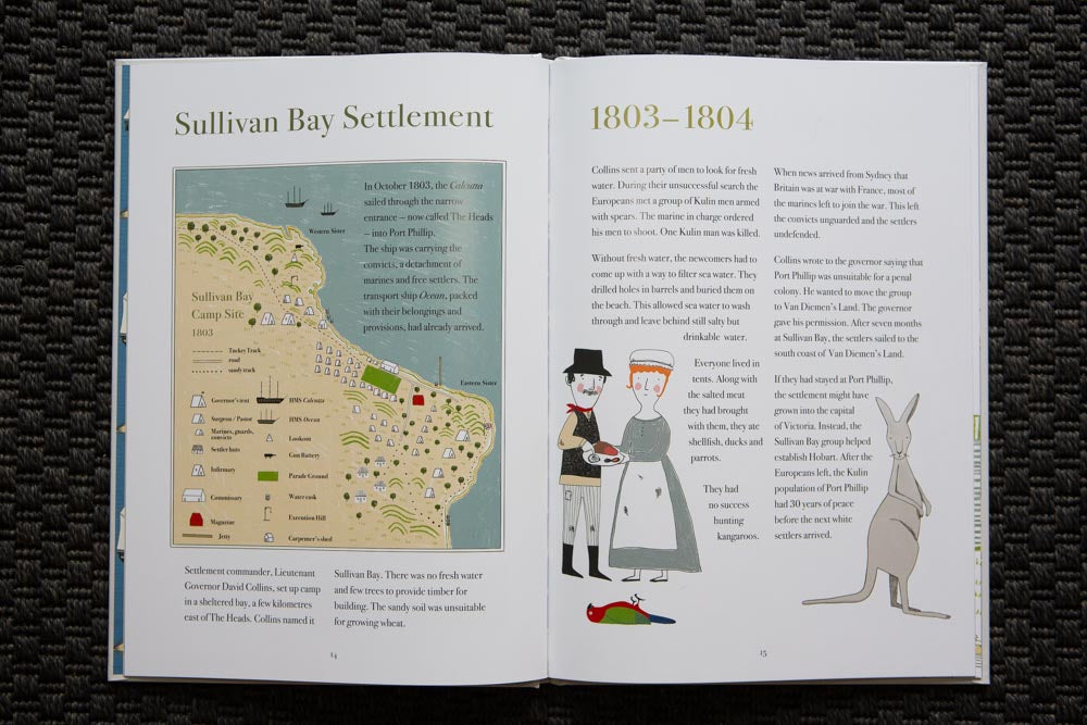 An open page of a children's book, on a dark blue textured mat