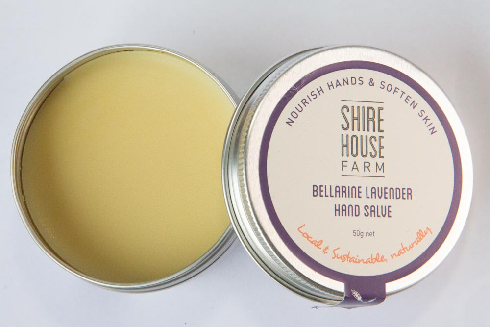 A tin of hand balm, with the lid off. On a white background