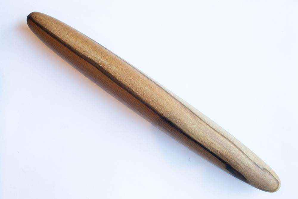 A wooden rolling pin on a white background