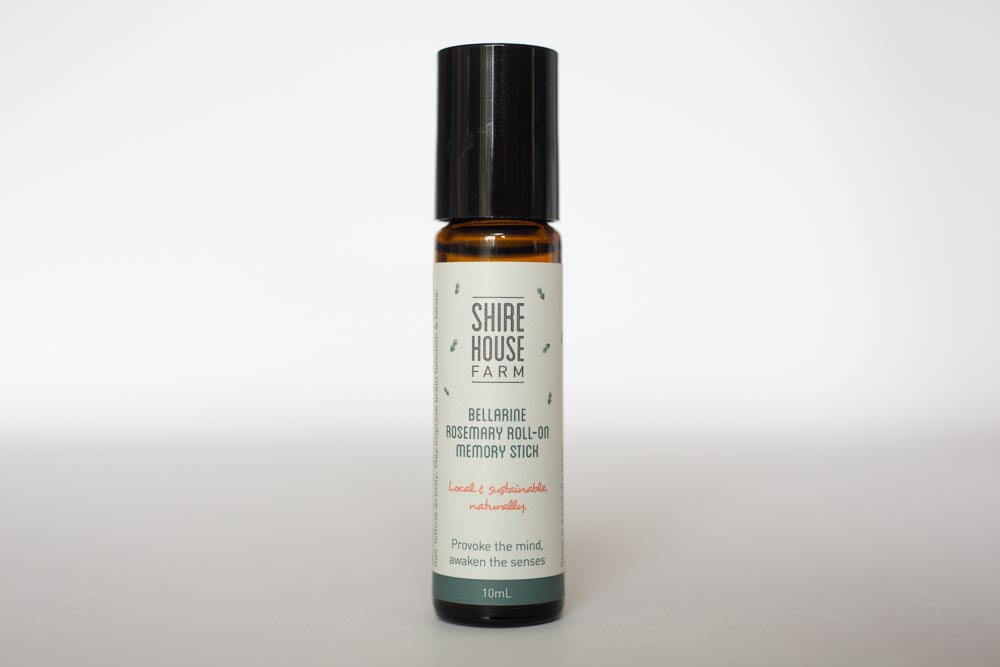 A bottle of rosemary essential oil roll on, on a white background